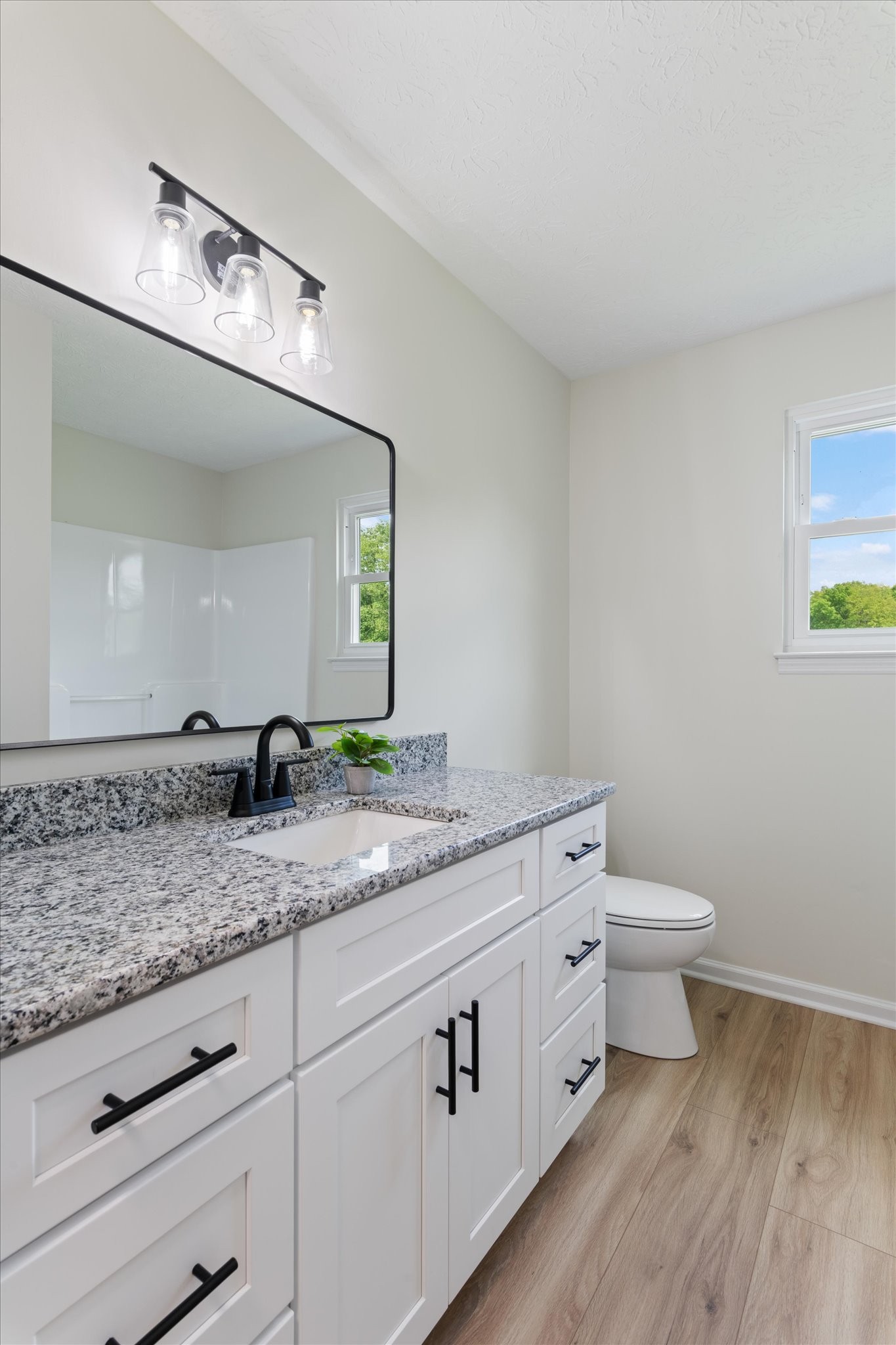 3671 Apache Trail Springfield, TN 37172 - Photo 16 of 28 a spacious bathroom with a granite countertop sink a toilet and a mirror