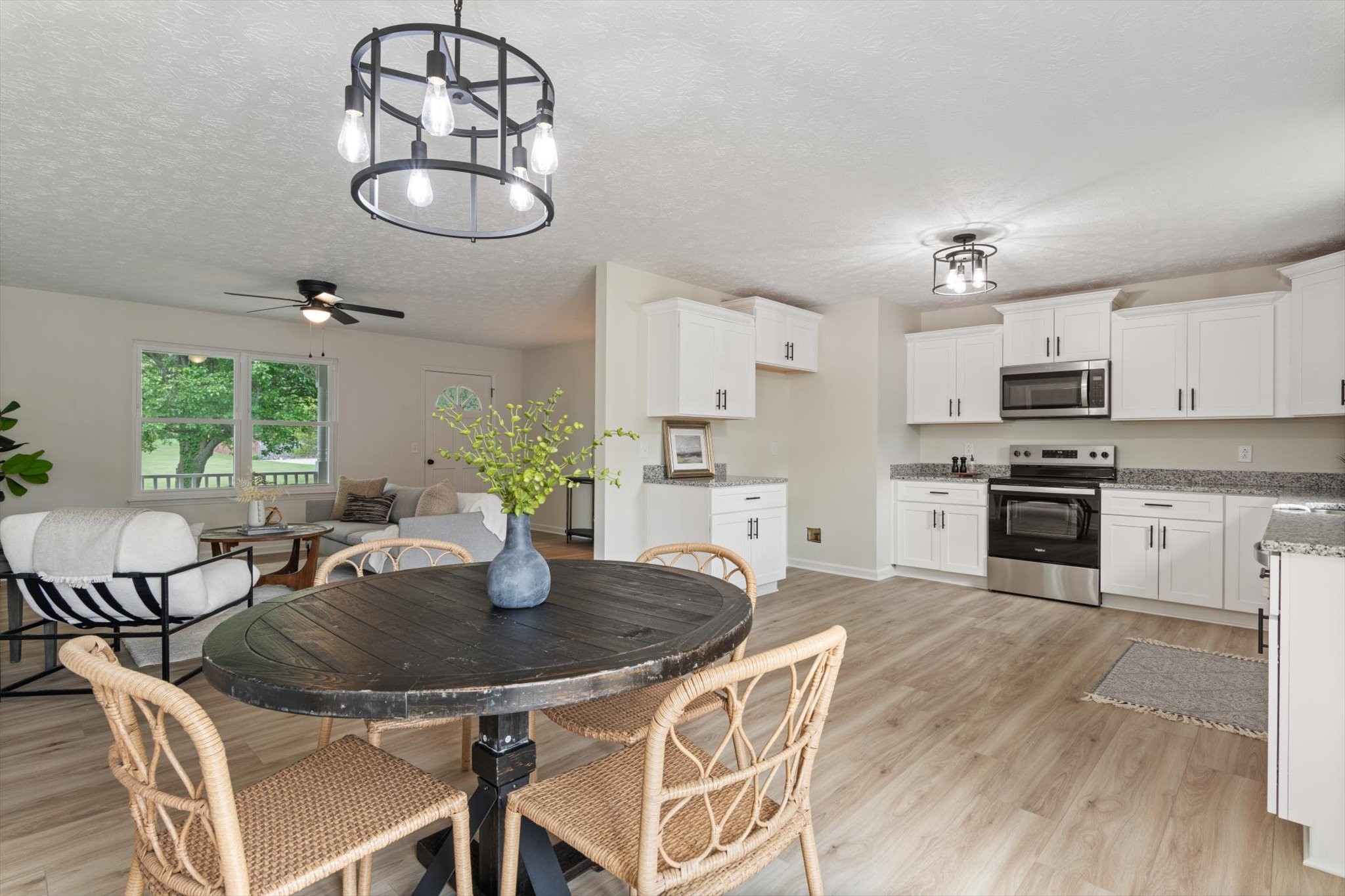 3671 Apache Trail Springfield, TN 37172 - Photo 8 of 28 a kitchen with stainless steel appliances granite countertop a dining table chairs and chandelier