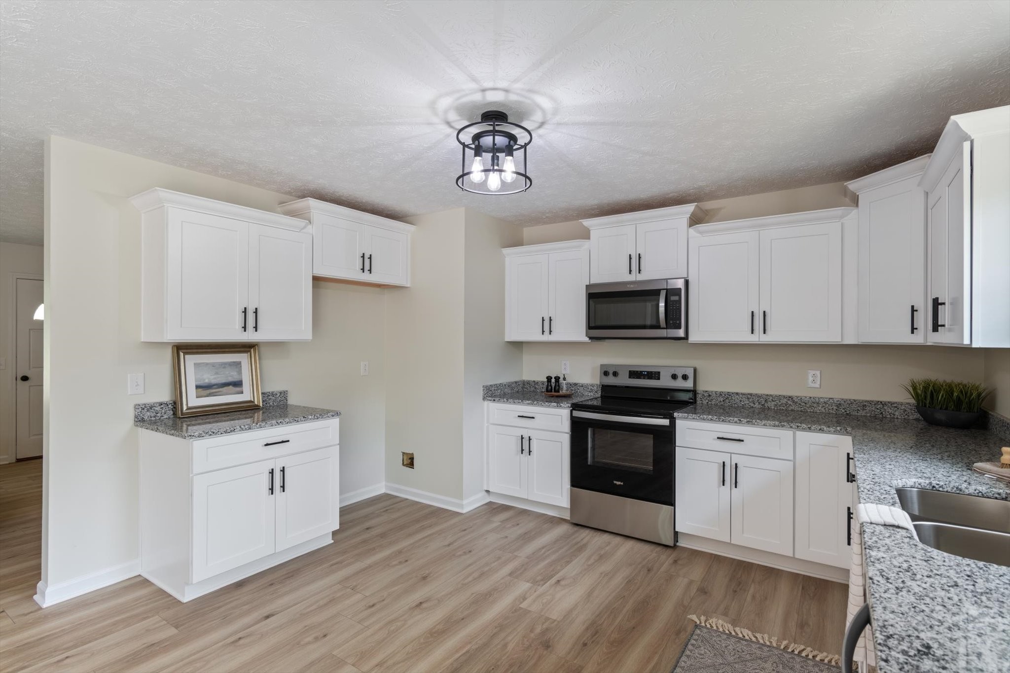 3671 Apache Trail Springfield, TN 37172 - Photo 10 of 28 a kitchen with granite countertop a center island stainless steel appliances and a window
