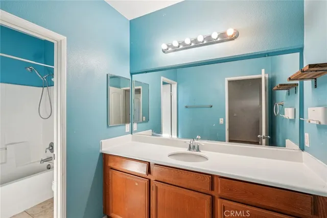 a bathroom with a double vanity sink and a mirror