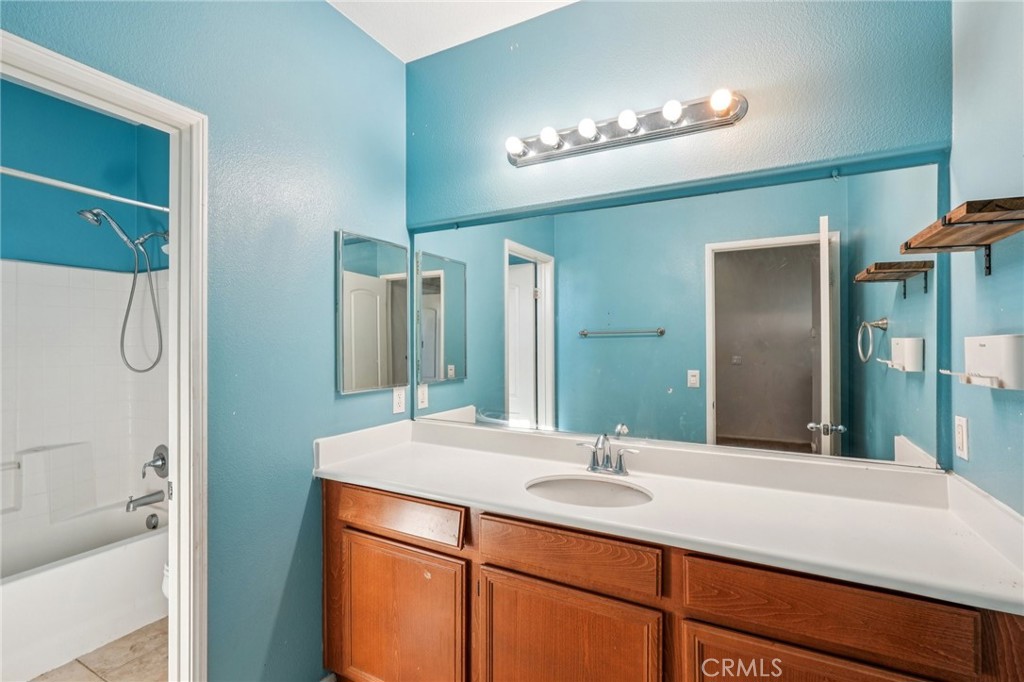 264 CLEOMELLA Court Hemet, CA 92543 - Photo 11 of 31 a bathroom with a double vanity sink and a mirror