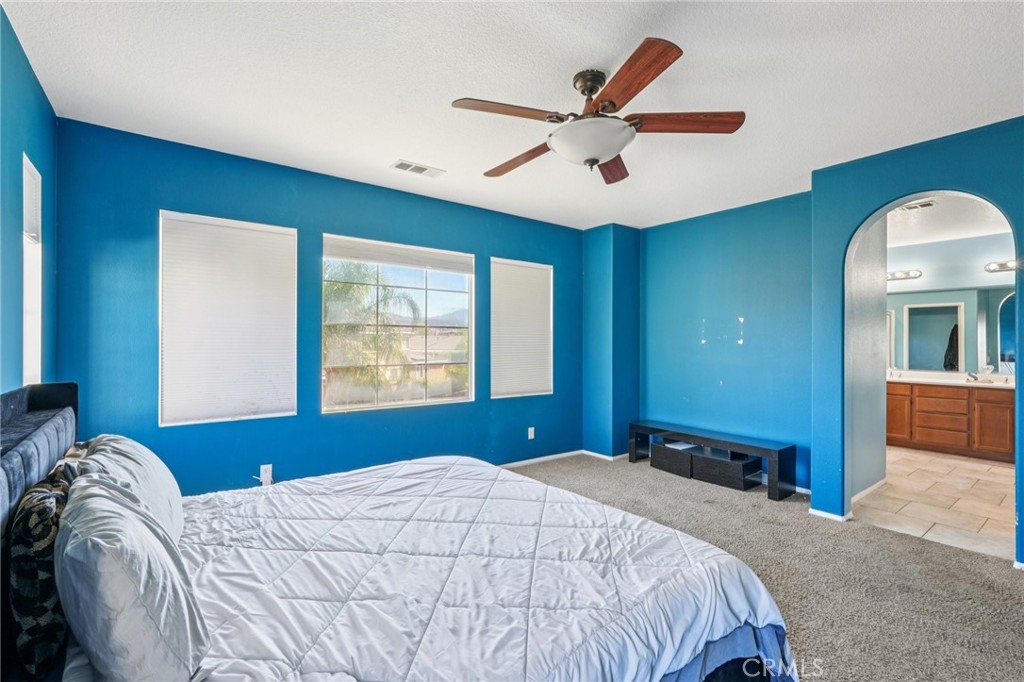 264 CLEOMELLA Court Hemet, CA 92543 - Photo 13 of 31 a bedroom with a large bed and a large window