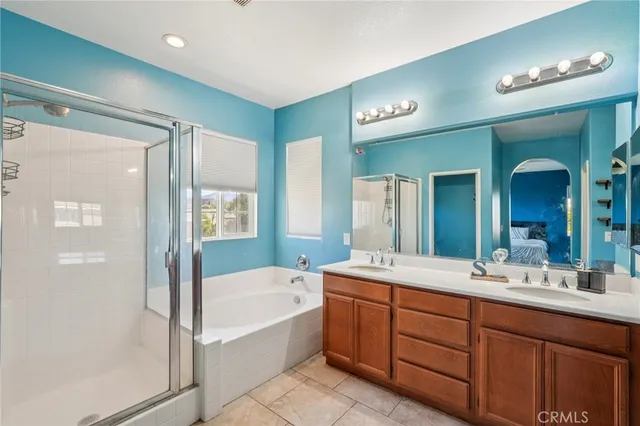 a bathroom with a tub a double vanity sink and a mirror