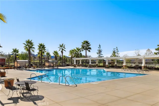 a view of a swimming pool with outdoor seating
