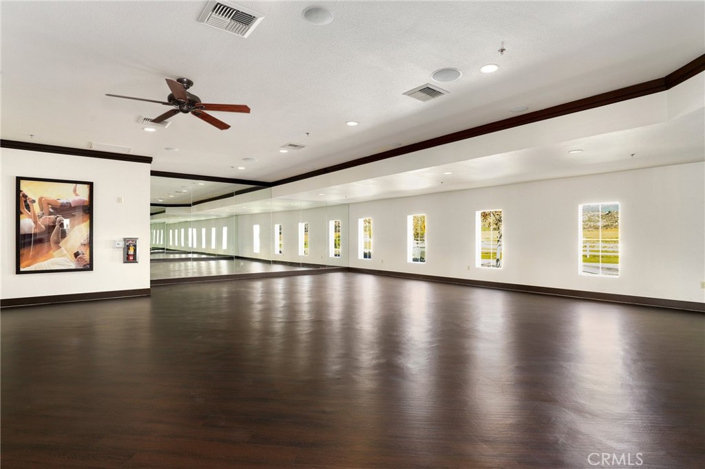 264 CLEOMELLA Court Hemet, CA 92543 - Photo 28 of 31 a view of a room with wooden floor ceiling fan and windows