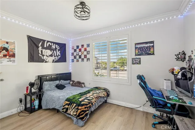 a bedroom with a bed and wooden floor