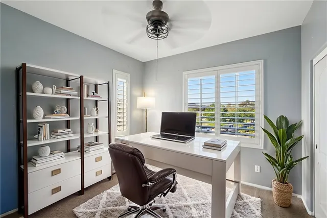 a view of a workspace with furniture and a potted plant