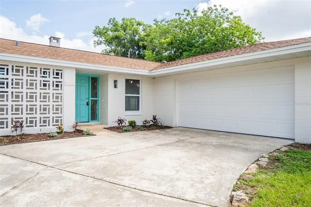 a view of a house with backyard and sitting area