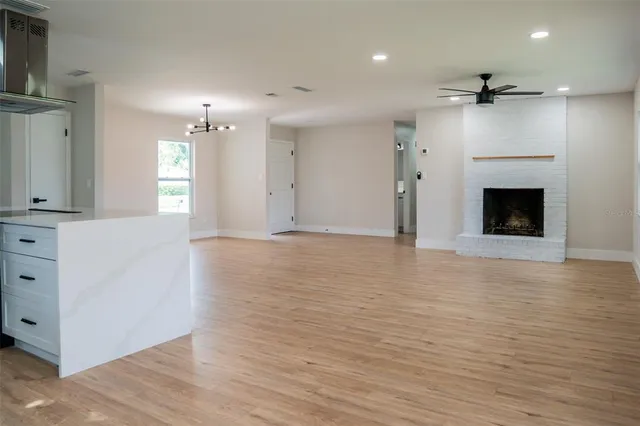 a view of a kitchen and an empty room