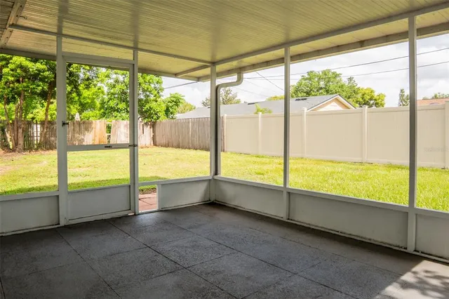 a view of an empty room with large windows