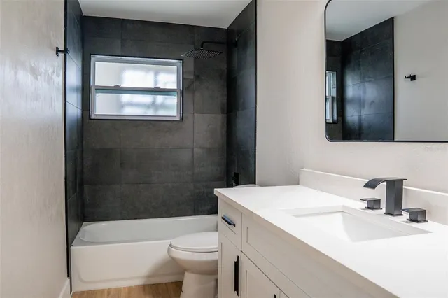 a bathroom with a sink a toilet and bathtub