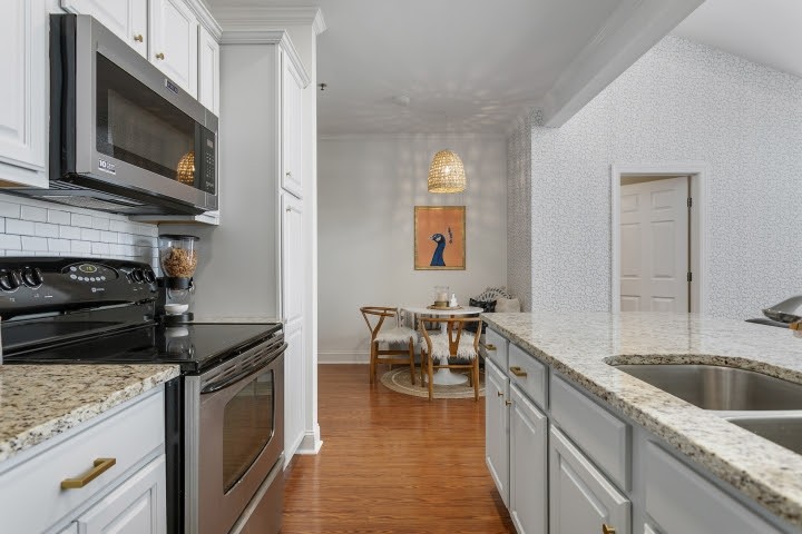 2010 Birch Lane Spring Hill, TN 37174 - Photo 11 of 47 a kitchen with stainless steel appliances granite countertop a sink stove and microwave