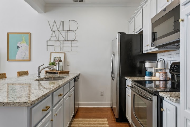 2010 Birch Lane Spring Hill, TN 37174 - Photo 10 of 47 a kitchen with stainless steel appliances granite countertop a sink stove and refrigerator