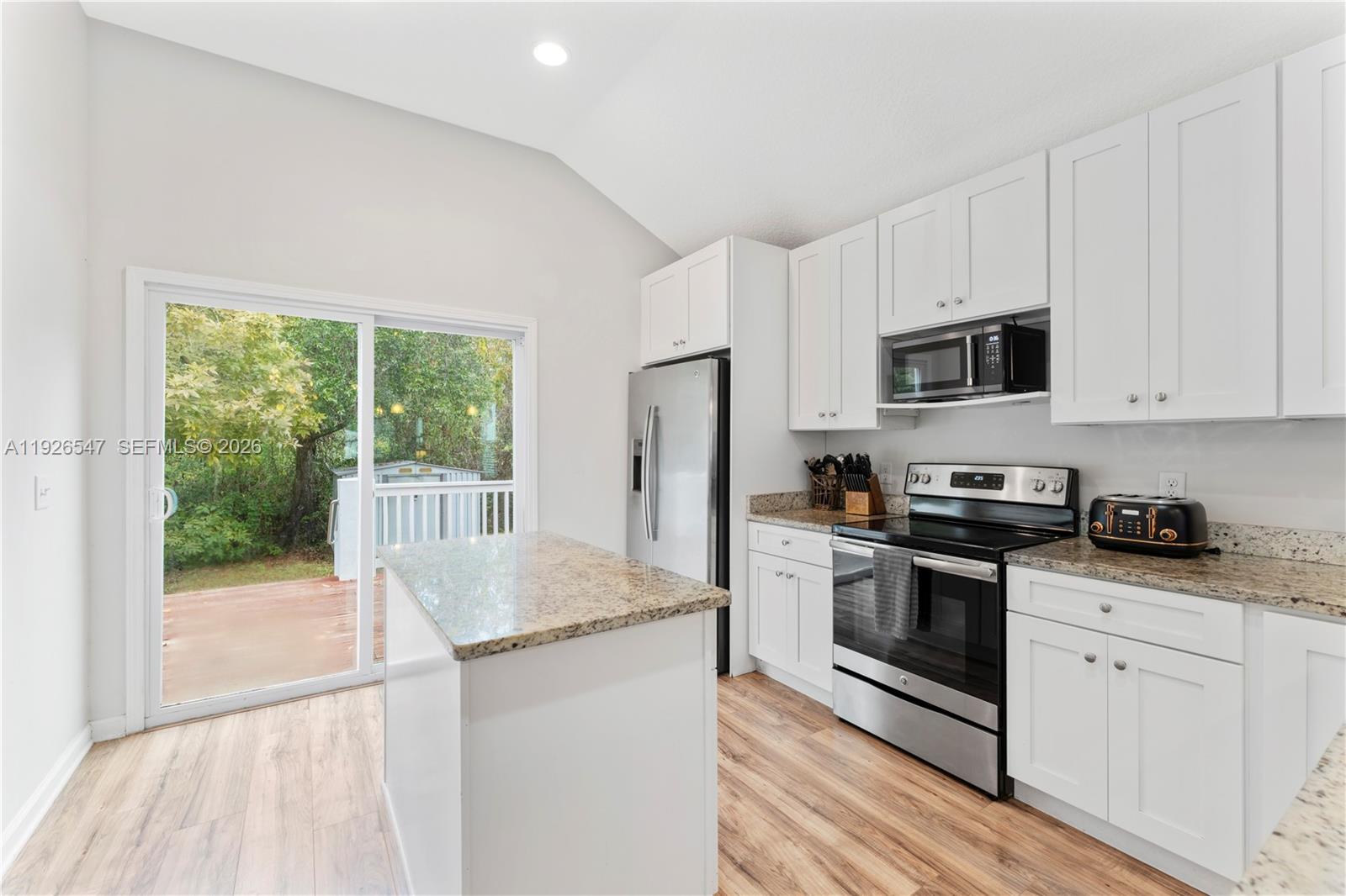 2 Poinciana Cove Road St. Augustine, FL 32084 - Photo 18 of 43 a kitchen with stainless steel appliances granite countertop a stove a sink and a refrigerator