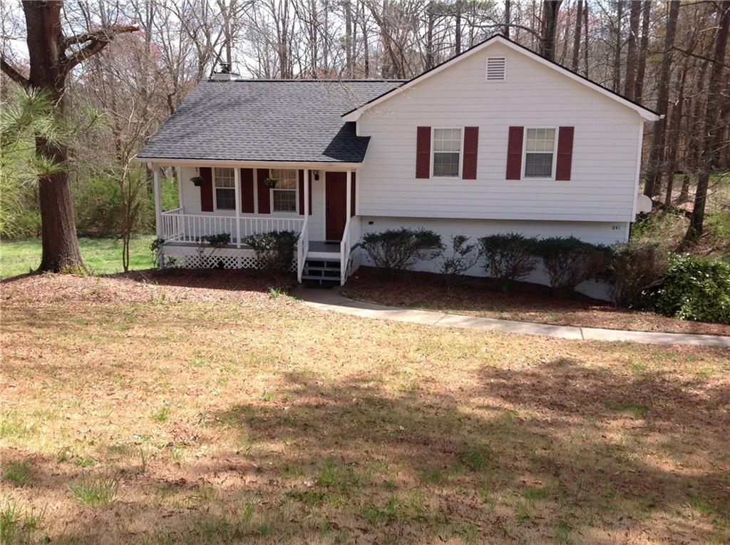 a front view of a house with a yard covered with snow
