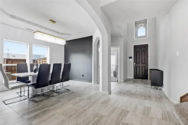 a view of a livingroom with chair and a dining table with wooden floor