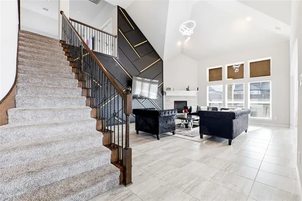 a living room with fireplace furniture and a window