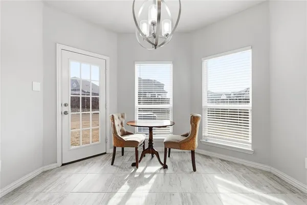 a view of a room with a large window and furniture