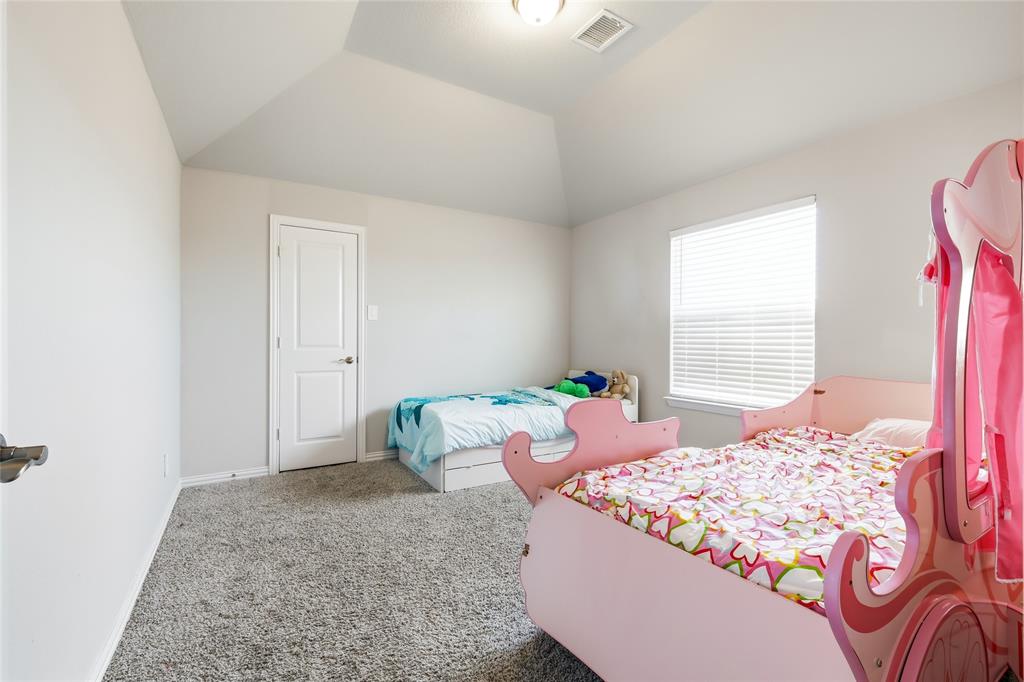 1315 Cascade Lane Forney, TX 75126 - Photo 22 of 36 a bed sitting in a bedroom next to a window