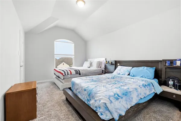 a bedroom with two beds and a couch