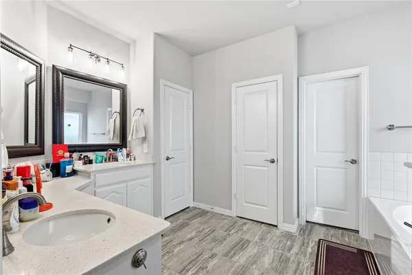 a bathroom with a sink vanity and a mirror