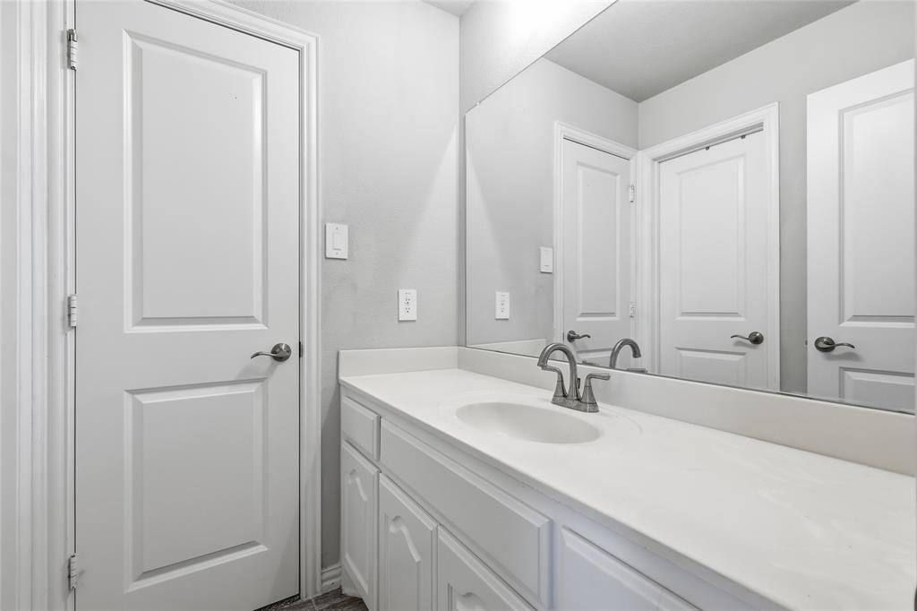 1315 Cascade Lane Forney, TX 75126 - Photo 27 of 36 a bathroom with a sink and a mirror