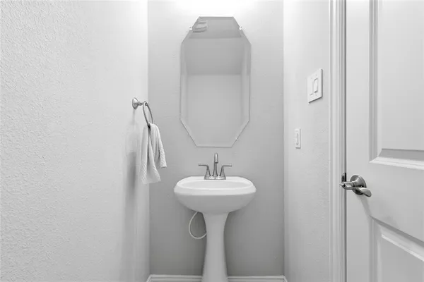 a bathroom with a sink a mirror and a window