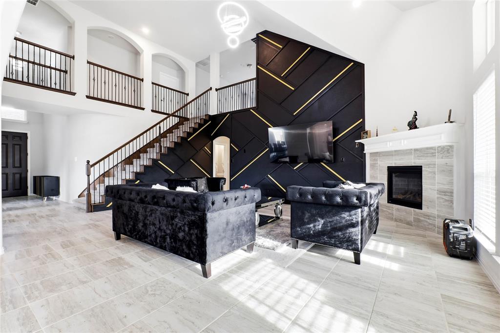 1315 Cascade Lane Forney, TX 75126 - Photo 3 of 36 a living room with furniture a fireplace and a ceiling fan