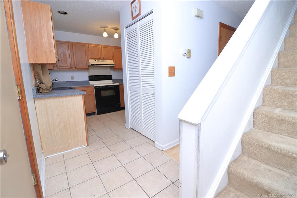 482 Lake Avenue, Unit 4 Bristol, CT 06010 - Photo 5 of 12 a kitchen with a refrigerator sink and cabinets