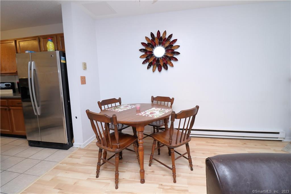 482 Lake Avenue, Unit 4 Bristol, CT 06010 - Photo 6 of 12 a view of a dining room with furniture and a chandelier