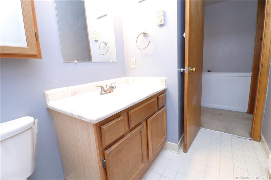482 Lake Avenue, Unit 4 Bristol, CT 06010 - Photo 7 of 12 a bathroom with a sink and a mirror