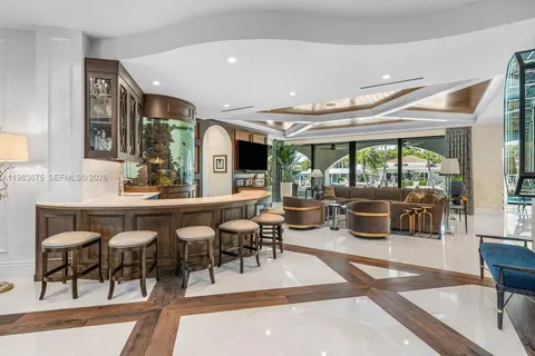 a kitchen with stainless steel appliances kitchen island granite countertop a table chairs and a sink