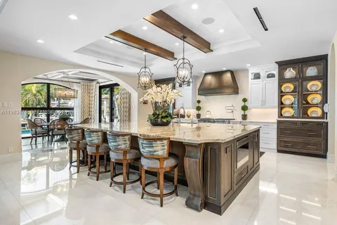 a dining room with furniture a chandelier and fireplace