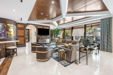 a dining room with furniture a chandelier and wooden floor