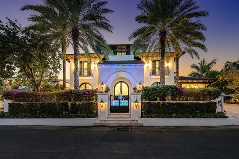 a front view of a house with a garden and a yard