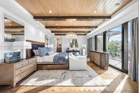 a bedroom with a large bed and a large window