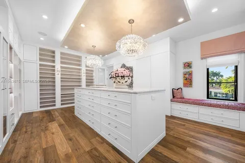 a spacious bedroom with a bed and a chandelier