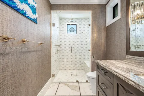 a bathroom with a granite countertop toilet a sink and bathtub