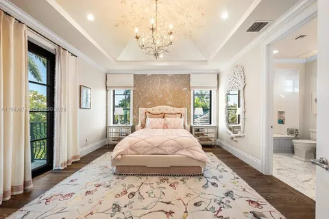 a large bedroom with a large bed and a flat screen tv