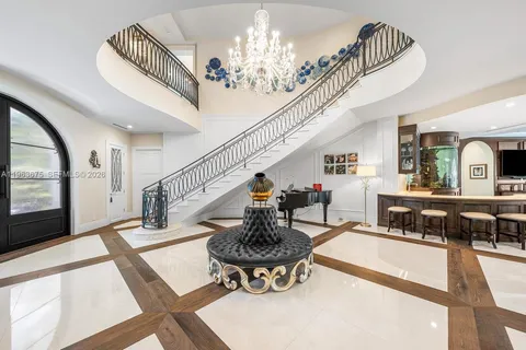 a view of a dining room with furniture a chandelier and wooden floor