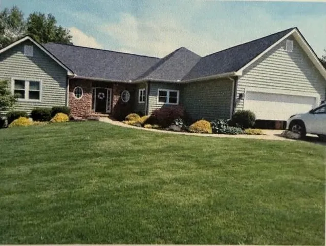 a front view of house with yard and seating space