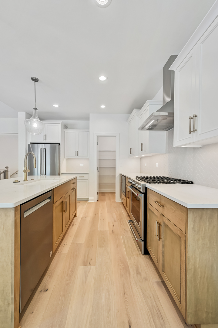 12260 Copper Ridge Drive, Unit 39 Lemont, IL 60439 - Photo 12 of 24 a large kitchen with stainless steel appliances double vanity and a sink