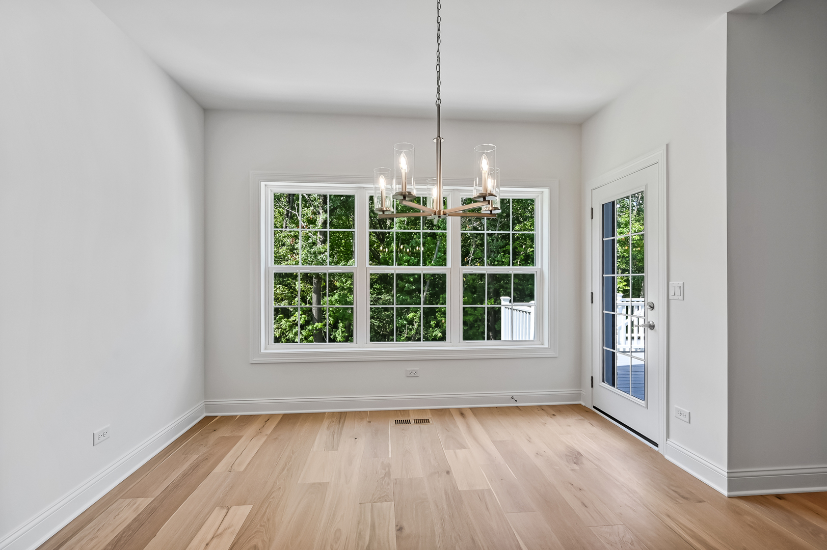 12260 Copper Ridge Drive, Unit 39 Lemont, IL 60439 - Photo 13 of 24 an empty room with wooden floor exposed radiator and windows