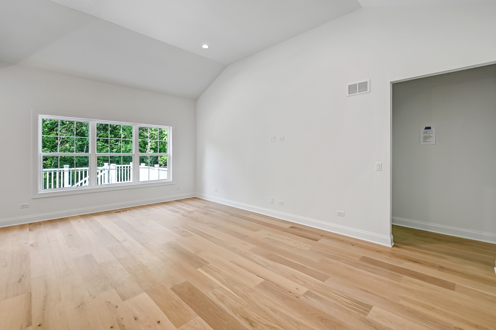 12260 Copper Ridge Drive, Unit 39 Lemont, IL 60439 - Photo 14 of 24 a view of an empty room with wooden floor and a window