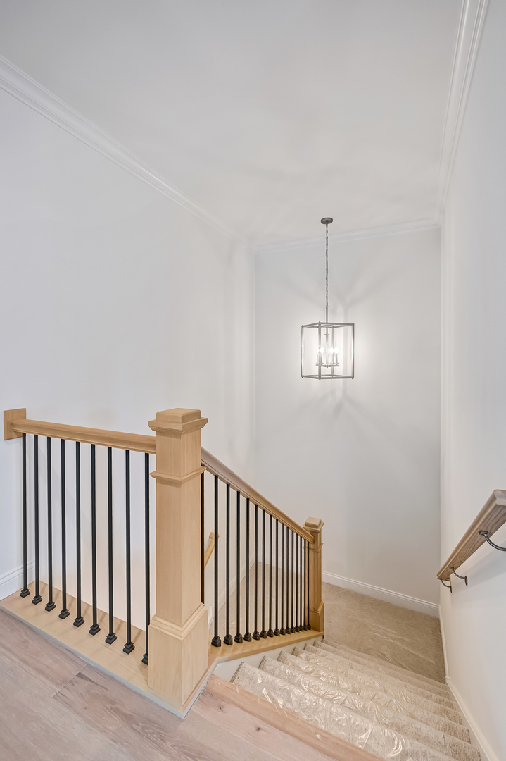 12260 Copper Ridge Drive, Unit 39 Lemont, IL 60439 - Photo 24 of 24 a view of staircase with railing and a chandelier