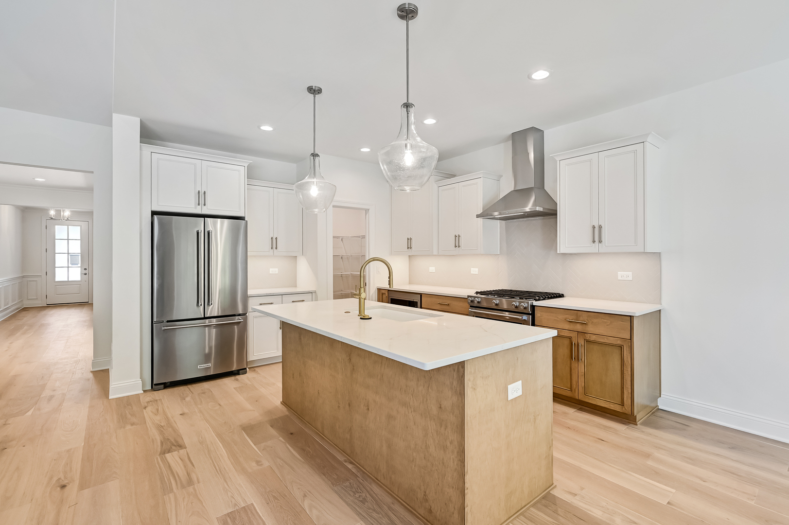 12260 Copper Ridge Drive, Unit 39 Lemont, IL 60439 - Photo 8 of 24 a kitchen with stainless steel appliances granite countertop a sink a stove a refrigerator and island with wooden floor