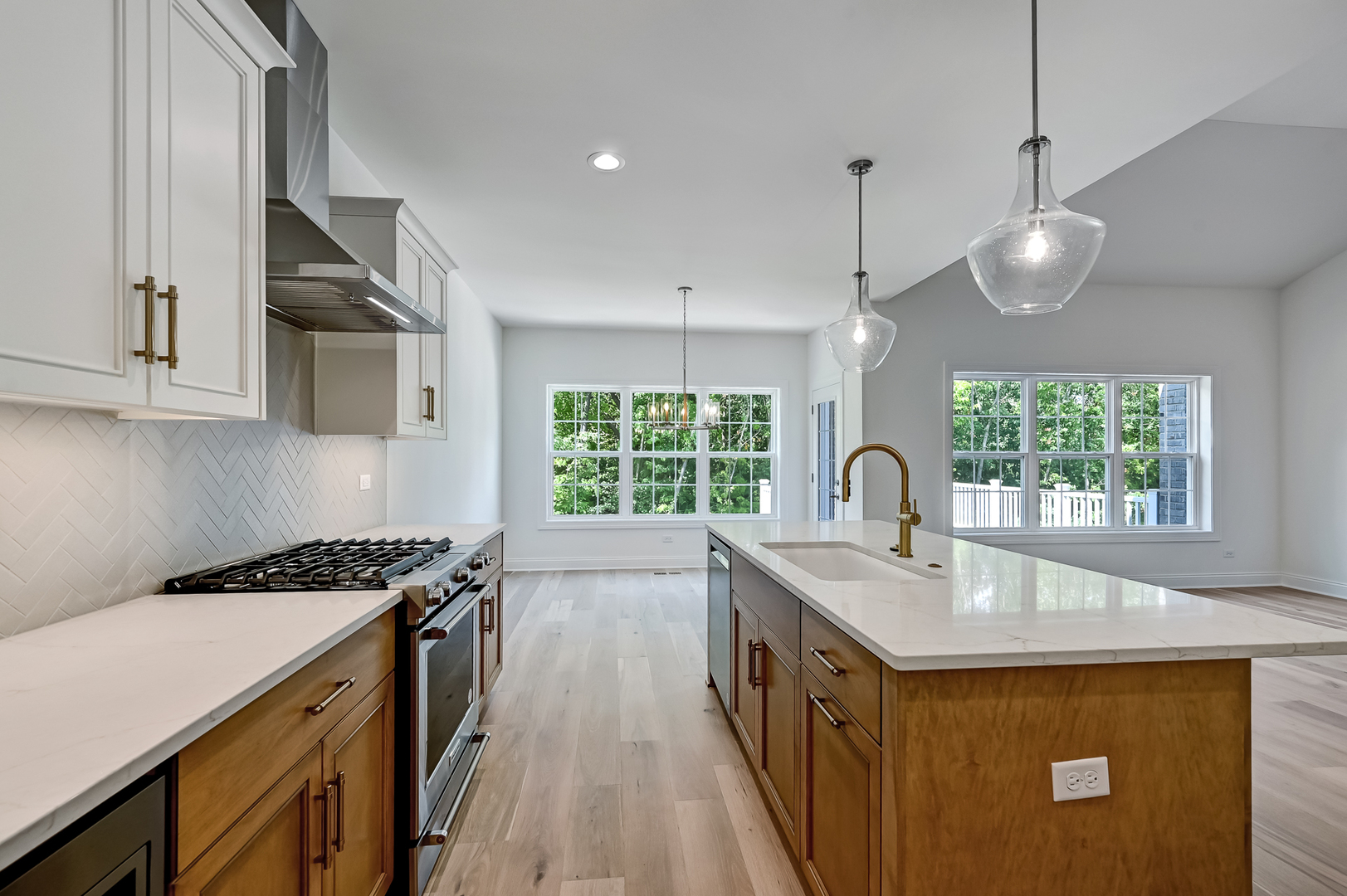12260 Copper Ridge Drive, Unit 39 Lemont, IL 60439 - Photo 9 of 24 a kitchen with kitchen island a sink appliances cabinets and a large window