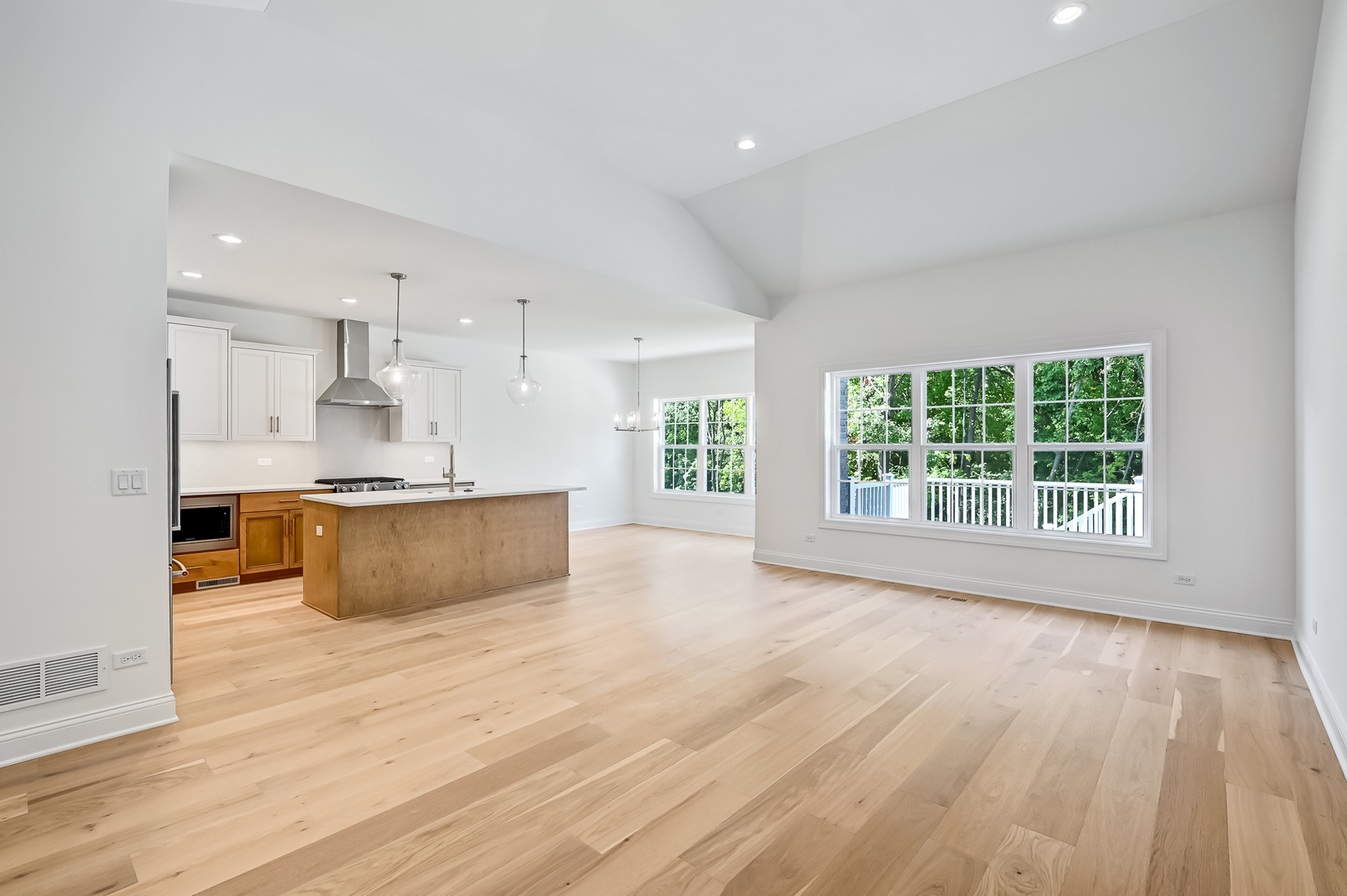 12260 Copper Ridge Drive, Unit 39 Lemont, IL 60439 - Photo 10 of 24 a large kitchen with kitchen island a sink wooden floor and a large window