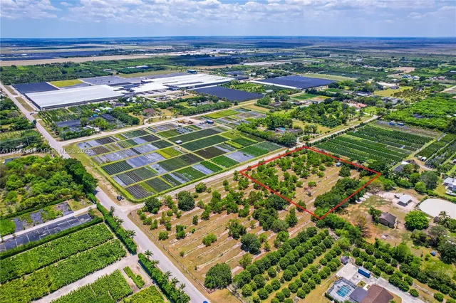 a view of a yard with wooden fence