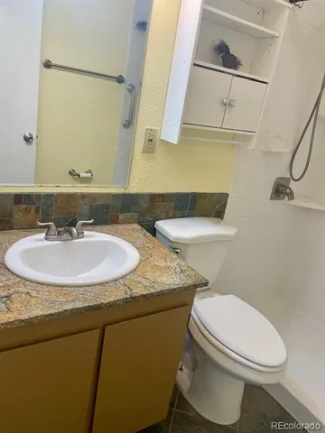a bathroom with a sink toilet and a mirror